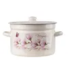 A cream-colored enamel pot with a lid, decorated with pink magnolia flowers and a small butterfly. Produktbild-Vorschau