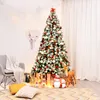 A decorated Christmas tree in a living room setting with a chair, pillows, and festive decorations. Anteprima dell’immagine prodotto