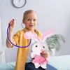 A young girl is playing doctor with a stuffed bunny. Anteprima dell’immagine prodotto