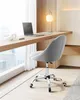 A grey office chair positioned at a wooden desk in front of a large window. Voir les images du produit