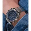 A close-up shot of a person's wrist wearing a silver and blue Guess watch. Voir les images du produit