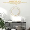 A modern living room setting with a round gold mirror on a white wall above a black console table. Náhľad obrázku produktu