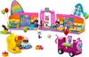 A colorful LEGO playset featuring a party room, a train, and various accessories, set against a white background. Produktbild-Vorschau
