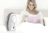 A woman is reading a book in bed while a baby monitor is placed on a table in the foreground. Produktbild-Vorschau