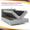 A grey upholstered bed frame with its storage compartments open, showcasing the storage space. Produktbild-Vorschau