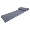 A gray foldable mattress with a headrest, lying on a white background. Produktbild-Vorschau