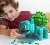 A young boy is playing with a large LEGO-style Bulbasaur toy. Produktbild-Vorschau