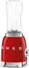 A red SMEG mini-standmixer with a clear glass blender jar is shown against a white background. Podgląd zdjęcia produktu