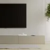 A power strip with a switch is placed on a modern entertainment center in front of a television. Náhled obrázku produktu