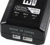Close-up of a black battery charger with labels and connectors. Podgląd zdjęcia produktu