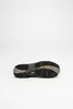 The sole of a shoe is shown against a white background. Voir les images du produit