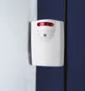A white alarm device with red indicator lights is mounted on a wall where two different colored walls meet. Anteprima dell’immagine prodotto