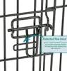 A close-up of a black metal dog crate latch with a text overlay describing a feature. Podgląd zdjęcia produktu