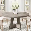 A round dining table with chairs in a dining room setting. Anteprima dell’immagine prodotto