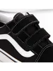 Close-up of a black Vans Old Skool V sneaker with white accents and velcro straps. Voir les images du produit