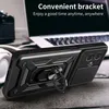 A black phone case with a ring stand is displayed on a wooden surface, with a laptop and headphones in the background. Produktbild-Vorschau
