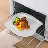 A plate of food is being removed from an oven. Produktbild-Vorschau