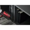 A close-up shot of a vacuum cleaner with a red dustbin, positioned next to a shelf with books. Produktbild-Vorschau