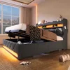 A bedroom scene with a bed that has its storage compartment open, revealing items inside. The bed has LED lighting around its base and headboard. Produktbild-Vorschau