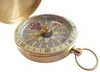 A close-up of a classic brass compass with its lid open, set against a white background. Produktbild-Vorschau