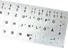 A close-up, overhead view of a sheet of silver keyboard stickers with black lettering. Produktbild-Vorschau