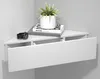 A white corner shelf with a drawer, a plant, and books on top. Produktbild-Vorschau