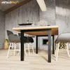 A dining table with chairs in a rustic interior setting, featuring a fireplace. Produktbild-Vorschau