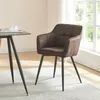 A brown upholstered dining chair with black metal legs sits next to a table in a well-lit room with a window. Náhled obrázku produktu