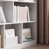 A close-up view of a white bookshelf with several books and a calendar on display. Podgląd zdjęcia produktu