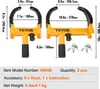 Two yellow wheel clamps with black rubber grips and measurement labels are displayed against a white background. Keys are also shown. Podgląd zdjęcia produktu