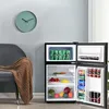 A mini refrigerator with its doors open, showing food and drinks inside, placed next to a chair with a blanket and a clock on the wall. Podgląd zdjęcia produktu