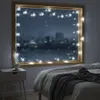 A cozy bedroom scene with snowflake string lights decorating a window overlooking a snowy cityscape at night. Náhled obrázku produktu