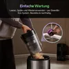A person is emptying a vacuum cleaner dustbin into a trash can, with an inset showing a part being rinsed under a faucet. Produktbild-Vorschau