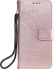 A rose gold flip case for a Samsung Galaxy Note20 with a mandala embossed pattern and a wrist strap. Produktbild-Vorschau