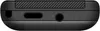 A close-up view of the bottom edge of a black mobile phone, showing the charging port and headphone jack. Produktbild-Vorschau