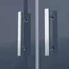 A close-up view of two chrome handles on a glass shower door. Produktbild-Vorschau