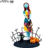 A collectible figure of Sally from The Nightmare Before Christmas, standing on a base with a black cat and pumpkins. Podgląd zdjęcia produktu