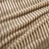 A close-up view of a textured fabric, likely a blanket or throw, showing its ribbed pattern. Produktbild-Vorschau