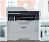 A Brother printer is placed on a desk in front of a window. Produktbild-Vorschau