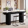 A black console table with two stools in front of a white sofa, in a living room setting. Produktbild-Vorschau