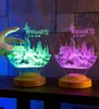 Two Hogwarts-themed LED lamps are displayed on a shelf in front of a stone wall. Produktbild-Vorschau
