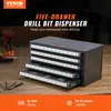 A five-drawer drill bit dispenser is shown on a wooden surface, with a drill and some drill bits in the foreground. Text overlays describe the product and its features. Produktbild-Vorschau