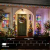 A decorated house entrance with Christmas lights and decorations. Produktbild-Vorschau