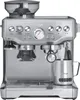 A front-facing studio shot of a silver espresso machine with a built-in grinder and milk frothing jug. Produktbild-Vorschau