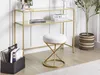 A modern living room or bedroom setting with a gold and glass console table, a white bouclé stool, and a potted plant. Produktbild-Vorschau
