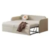 A beige sofa bed is shown pulled out, with a brown throw blanket and a white flower-shaped pillow on the mattress. Anteprima dell’immagine prodotto