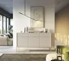 A modern living room with a sideboard, sofa, and abstract art. Voir les images du produit
