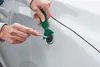 A person is using a dent repair tool on a car door. Produktbild-Vorschau