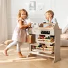 Two children are playing with a wooden toy shop counter. Náhled obrázku produktu