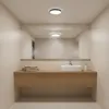 A modern bathroom with a floating vanity, sink, and mirror. Podgląd zdjęcia produktu